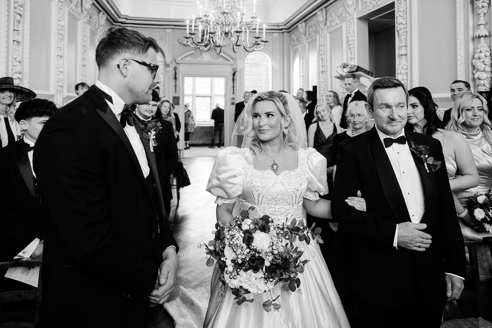 Black and white photo montage showing candid moments from an elegant wedding reception with guests mingling and dancing.