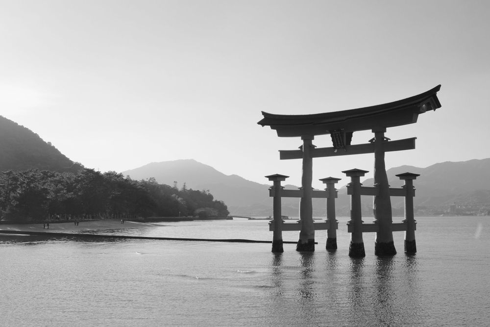The iconic floating torii gate of Itsukushima Shrine stands in the calm waters off Miyajima Island, Japan.