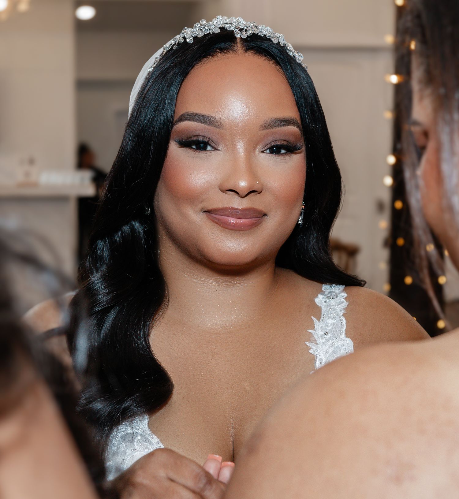 Bridal beauty portrait showcasing sparkling tiara and flowing dark hair.
