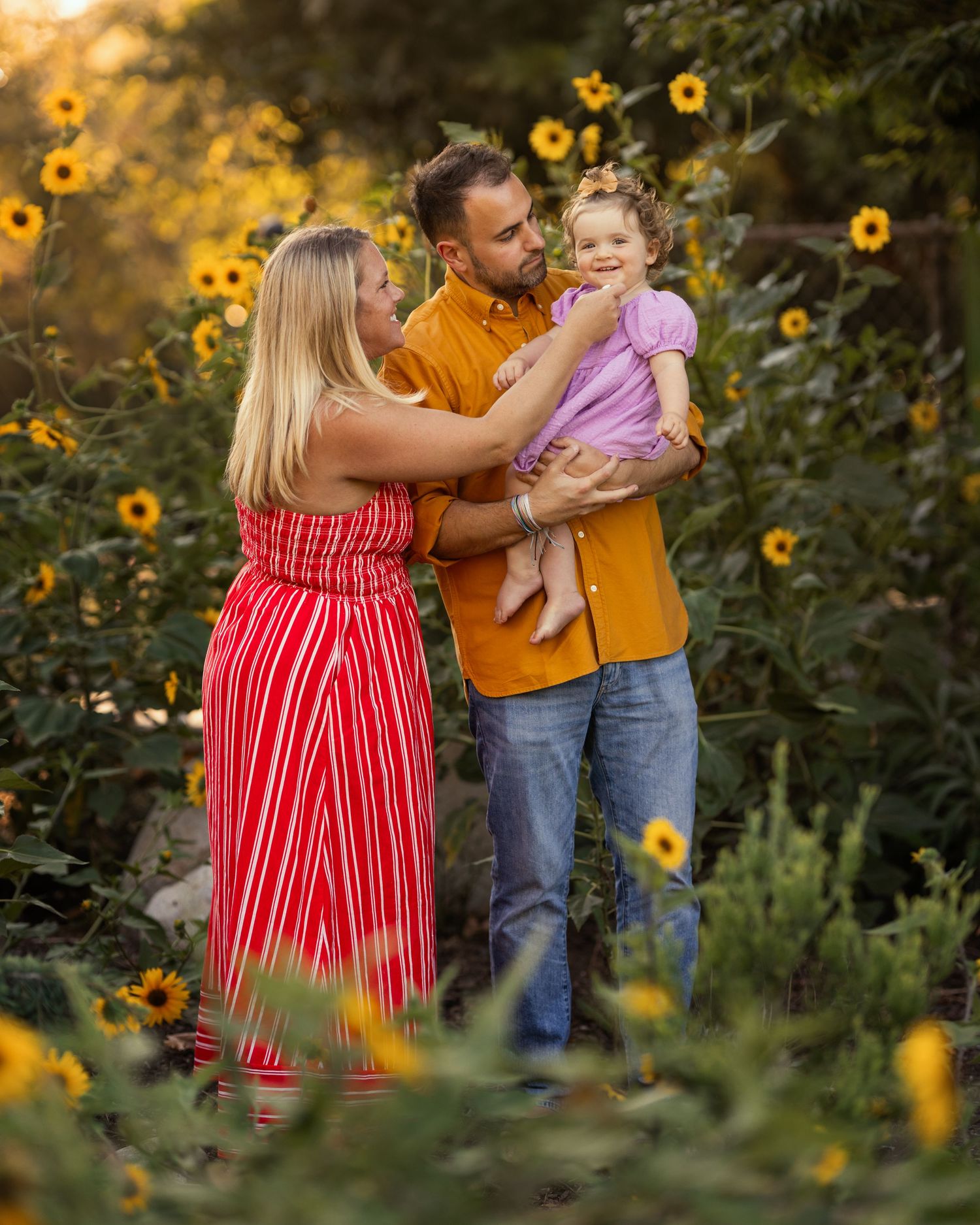 Kasha Gage and family in field of flowers during sunset photo session in Orange County with Meg Loeks.