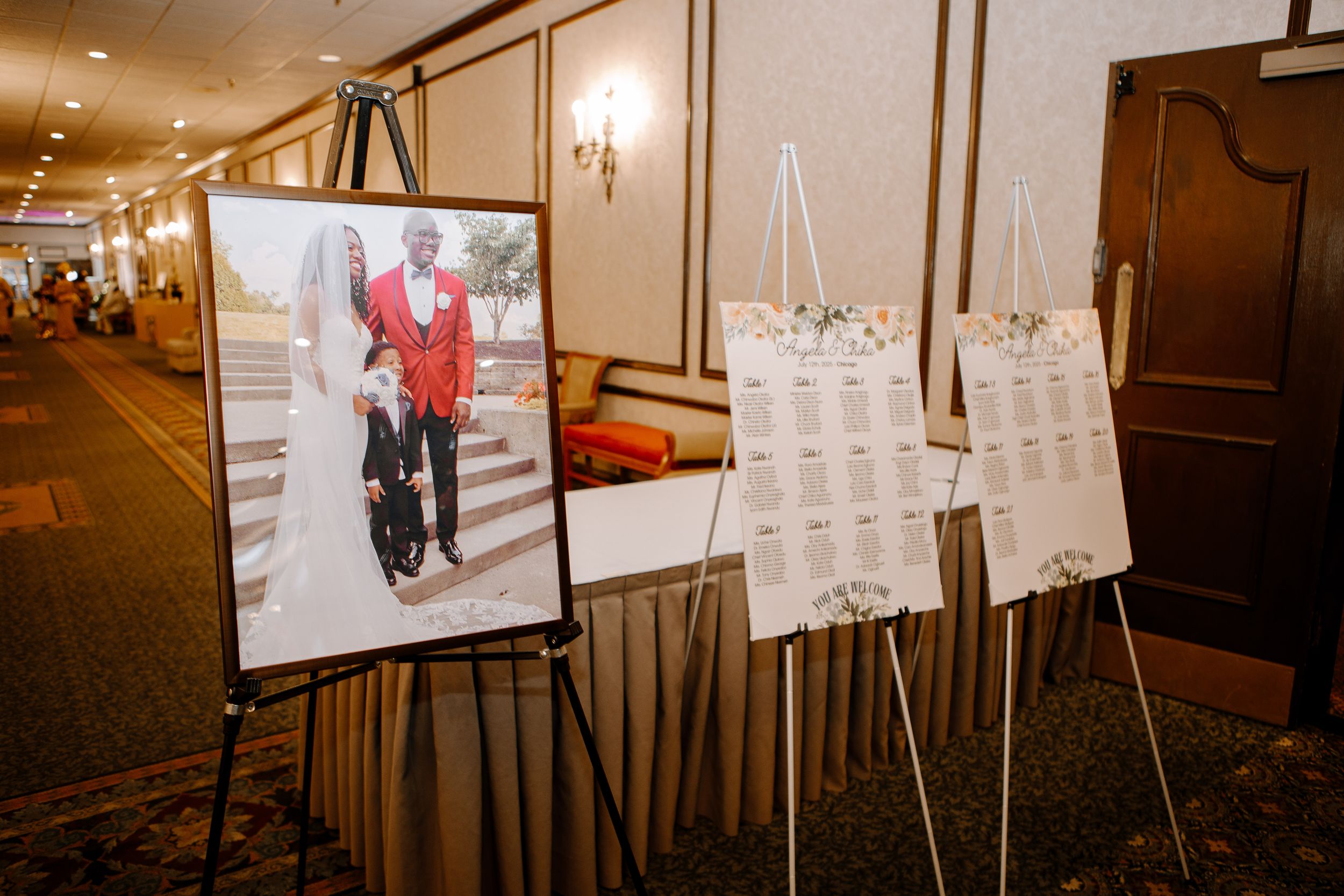 Photographs and documents on display boards at an exhibition with warm lighting in an indoor venue.