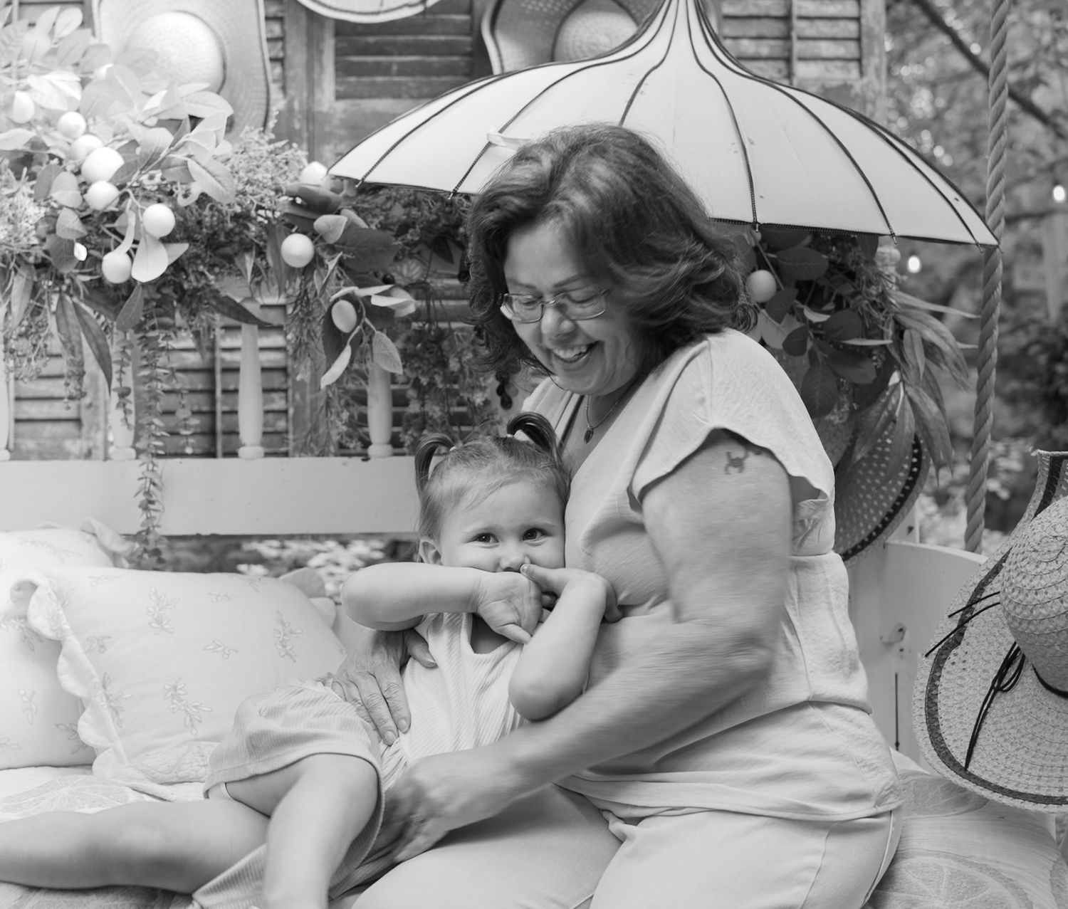 Vintage photo of people relaxing outdoors with umbrellas and casual summer attire.