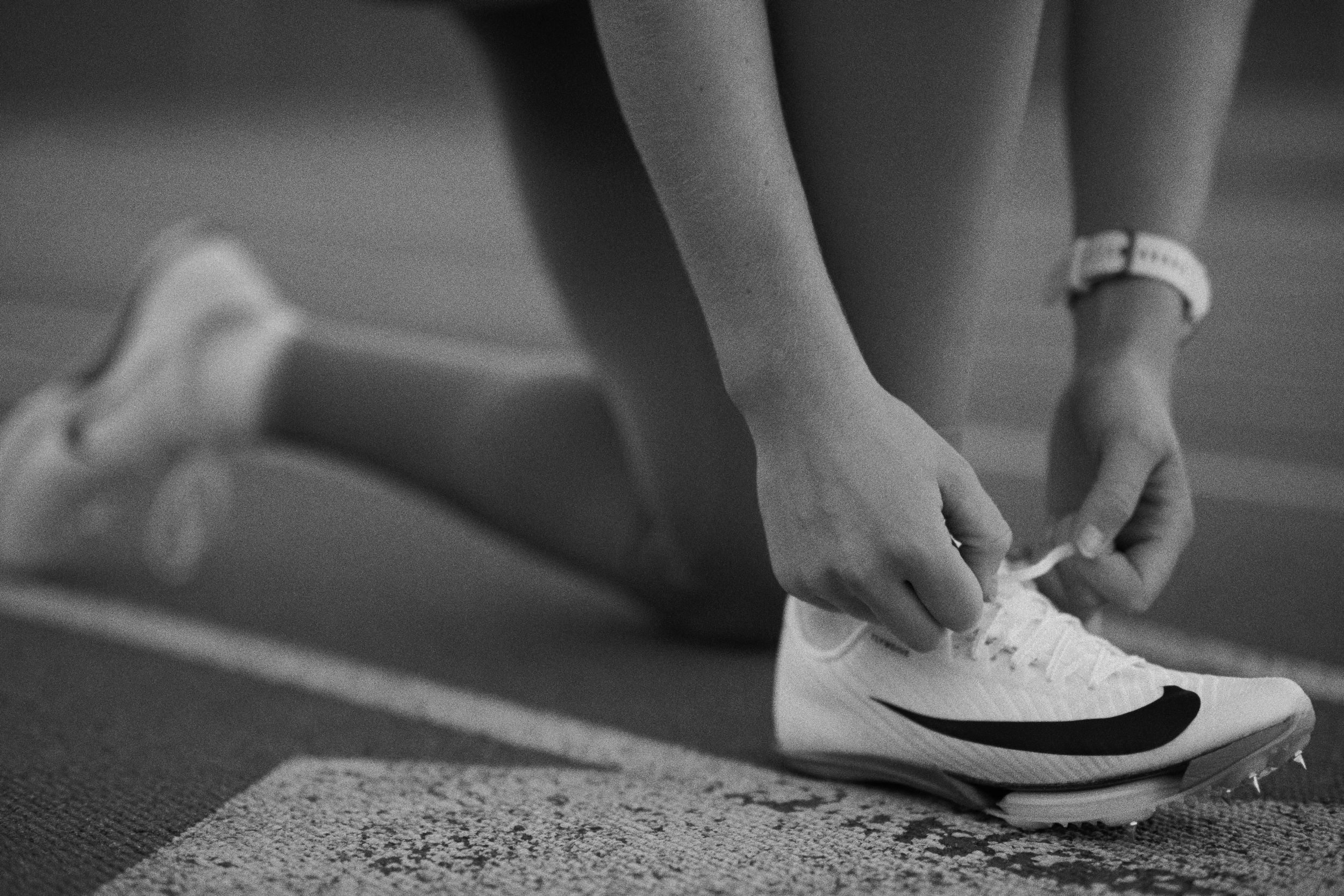 Black and white collage showing various cropped views of hands adjusting white sneakers and shoelaces on feet.