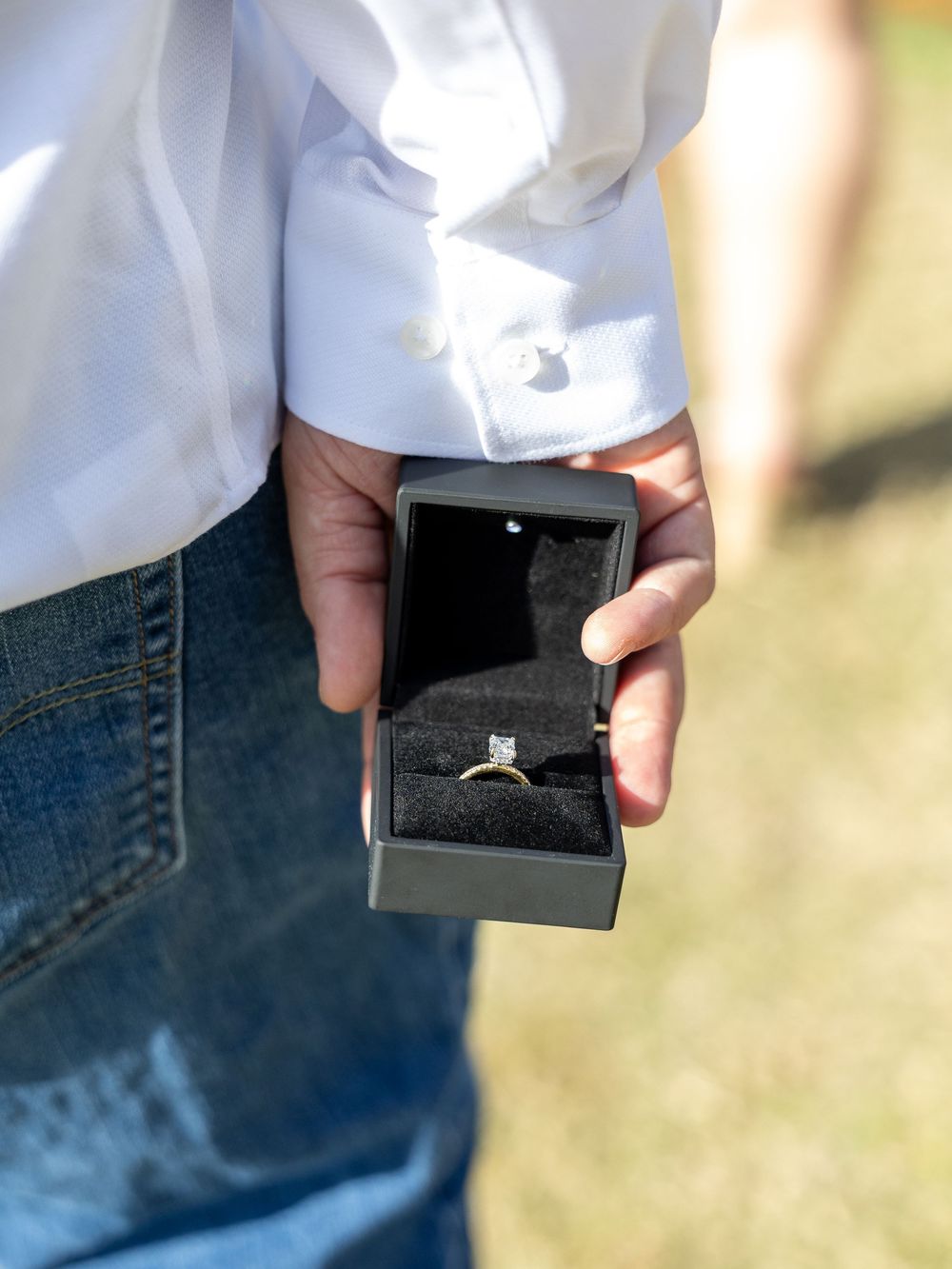Close-up shots of hands holding a small black box in sequence.