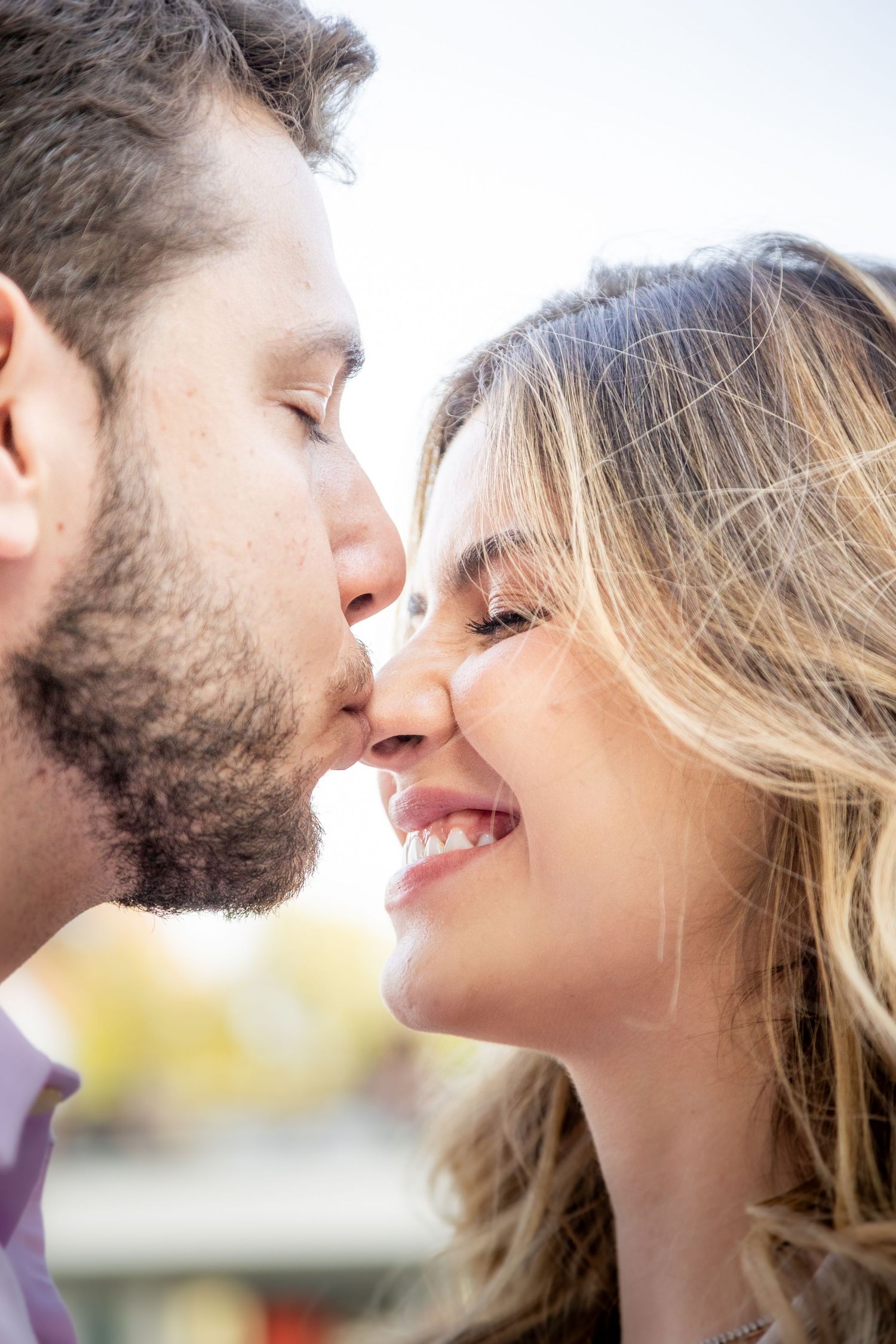 A romantic close-up series showing an intimate tender moment between a bearded man and woman with blonde hair.