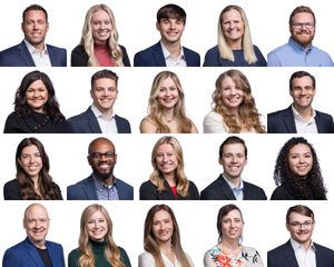 Row of professional business portraits with employees smiling against neutral backgrounds.