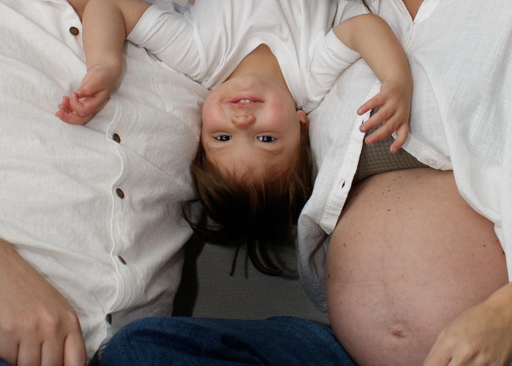 A series of close-up photos showing a baby's small hands and feet in white clothing.