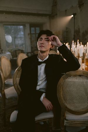 Formal evening scene with vintage chairs and candlelight creating dramatic ambiance.