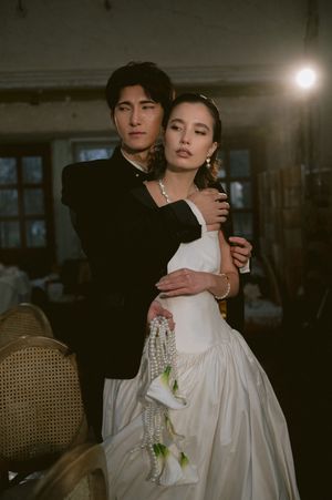 Moody wedding photography series showing romantic couple embracing in vintage-style formal attire.