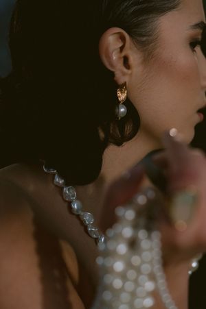 Sparkling crystal earrings and jewelry details captured in an elegant bridal portrait.