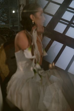 Artistic bridal portrait series with dramatic shadows and white wedding gown.