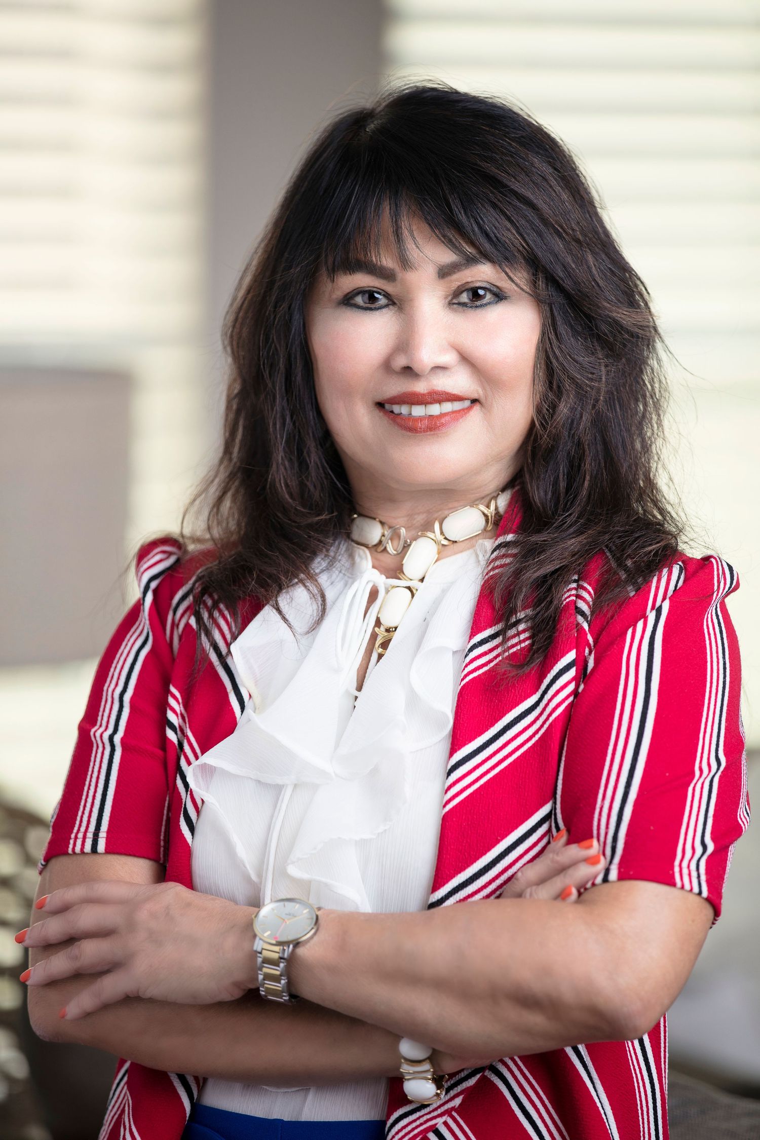 Professional portrait series showing person in red and white striped outfit with bright smile.