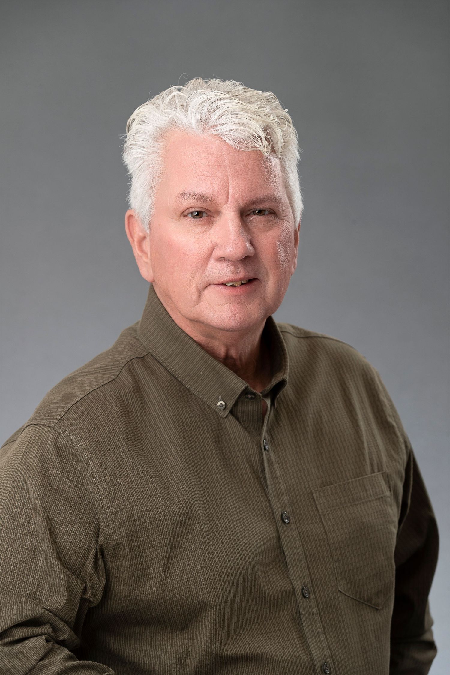Headshot series of person in olive button-up shirt against grey background.