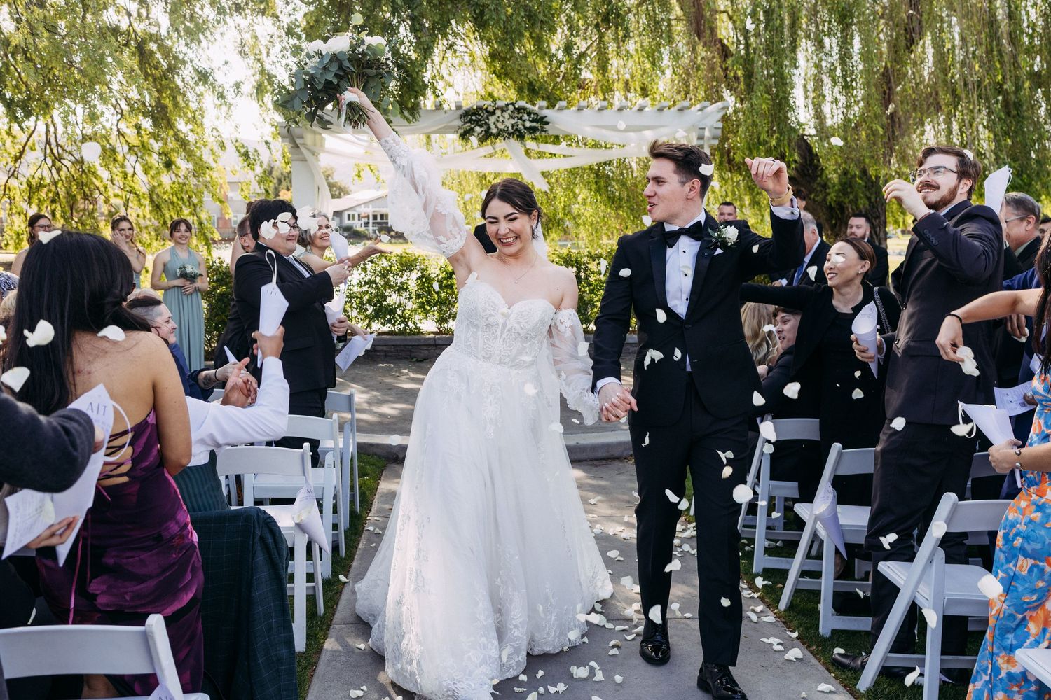 Newlyweds walk down the aisle at San Ramon Waters. Image captured by top Bay Area wedding photographer