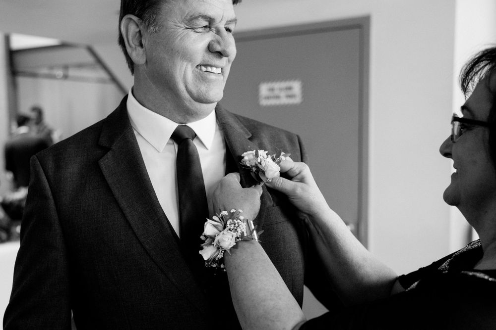 A montage of four black and white photos showing candid moments of joy and laughter during a formal celebration event.