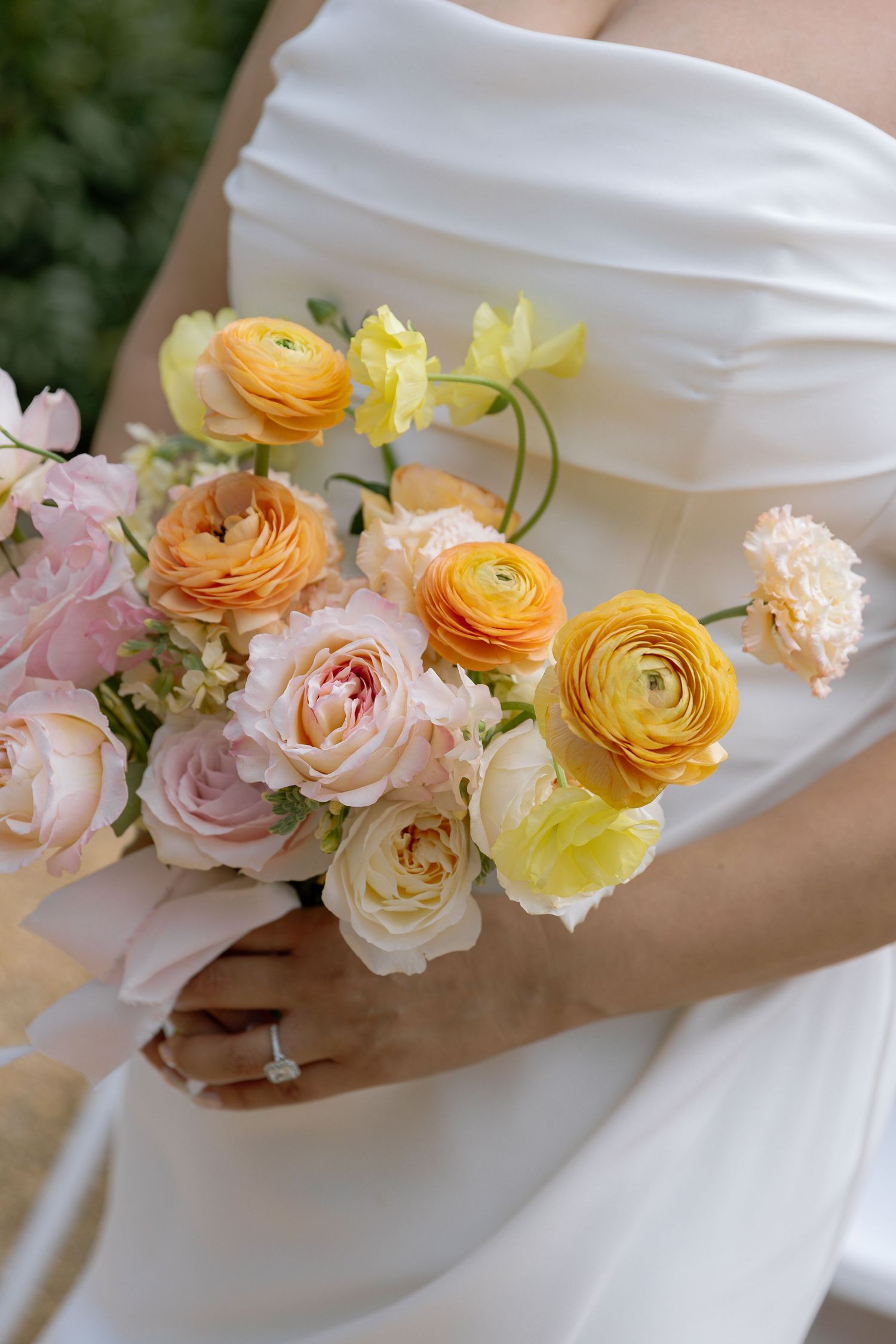 Bride in elegant wedding attire during their outdoor ceremony with greenery and decorative columns at The Andrews Farm, Spring Wedding in NC