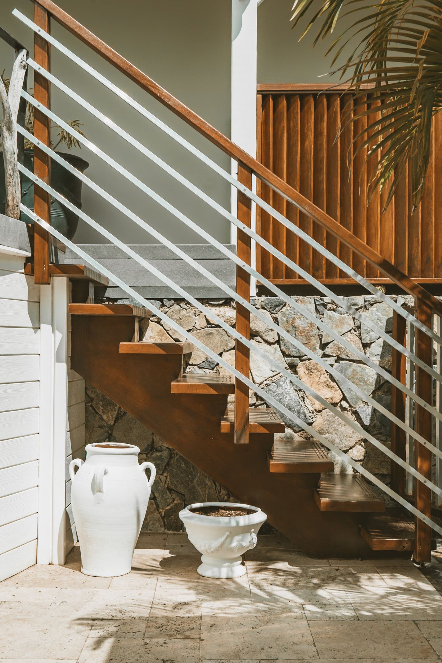 Collection of modern wood and metal staircase images with construction materials and fragments underneath.
