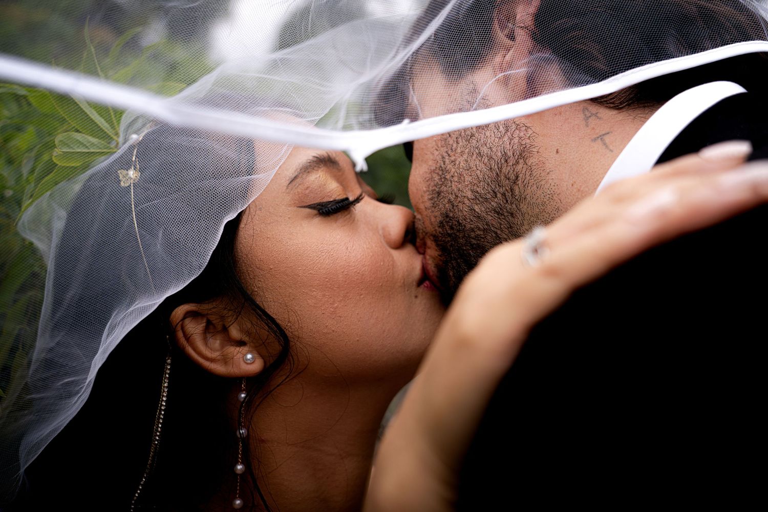 A romantic wedding photoshoot sequence showing close-up shots of couples sharing intimate kisses under a white veil.