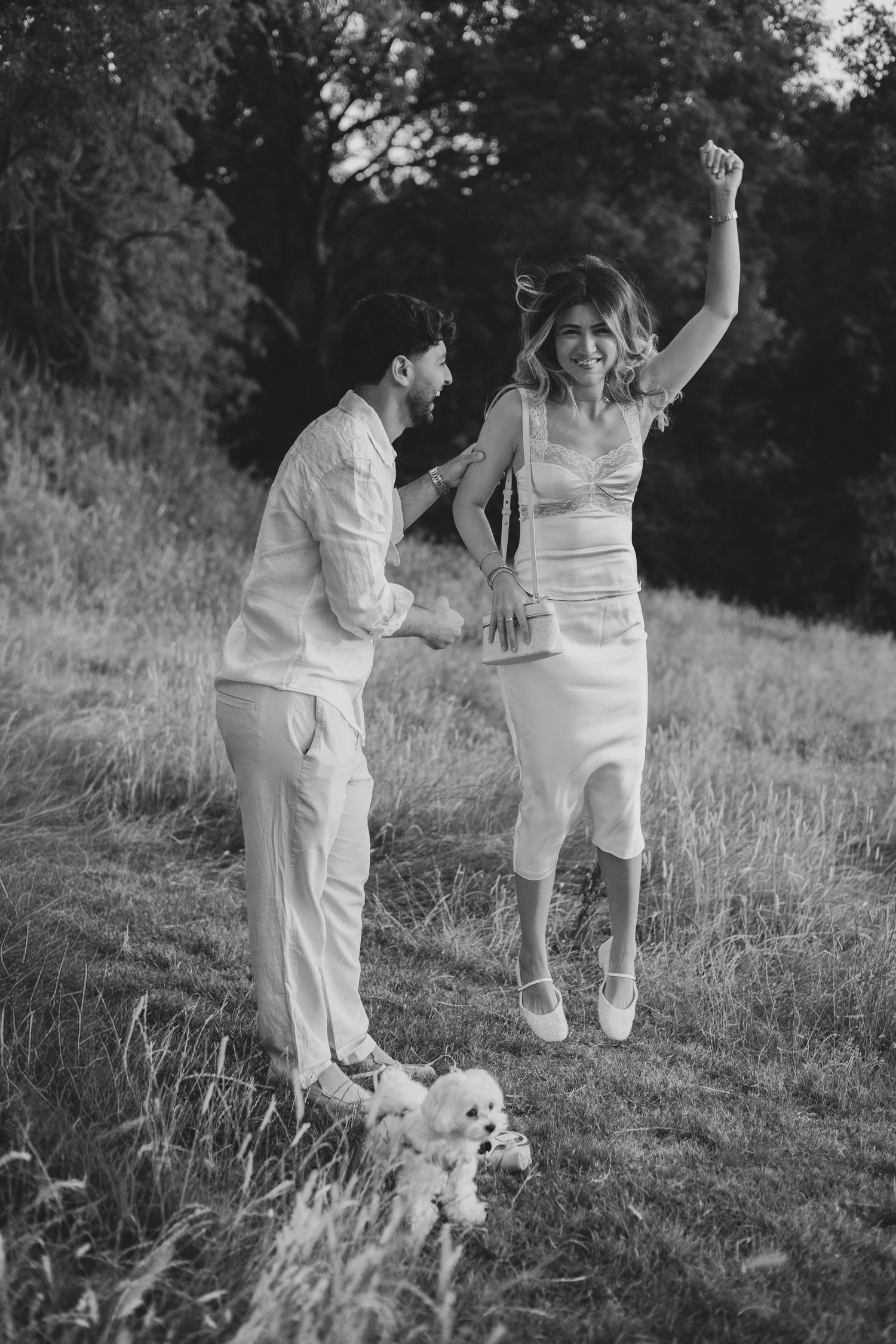 Black and white romantic sequence of a couple celebrating together at Foxhill Manor at sunset for their Cotswolds proposal photoshoot.