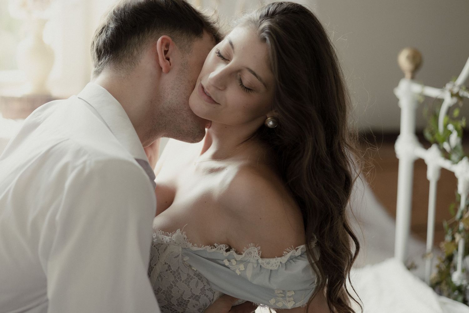 A romantic collage of wedding photos showing tender moments between a couple in wedding attire.