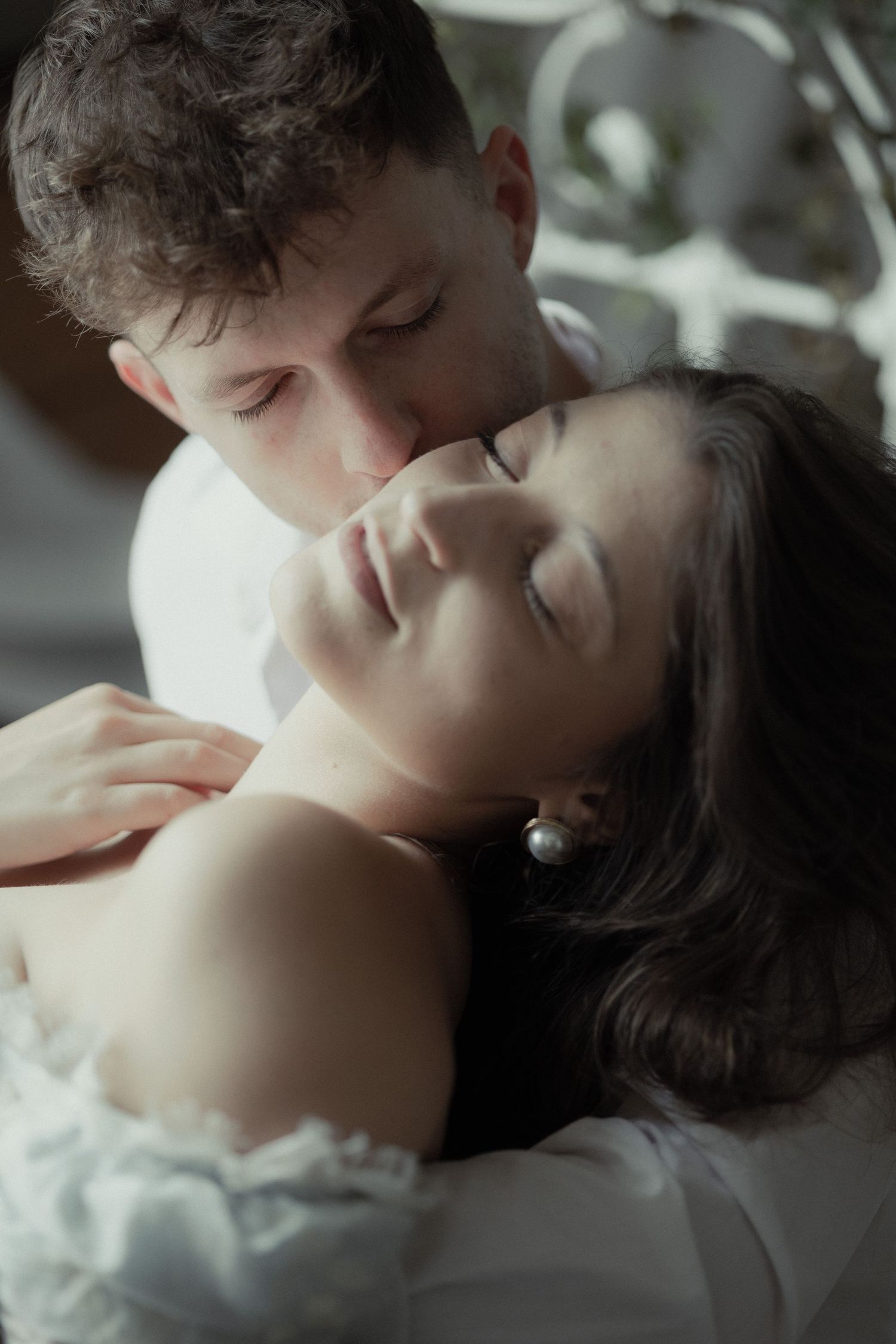 A romantic and intimate black and white photo series showing a tender embrace and passionate moment between two people.