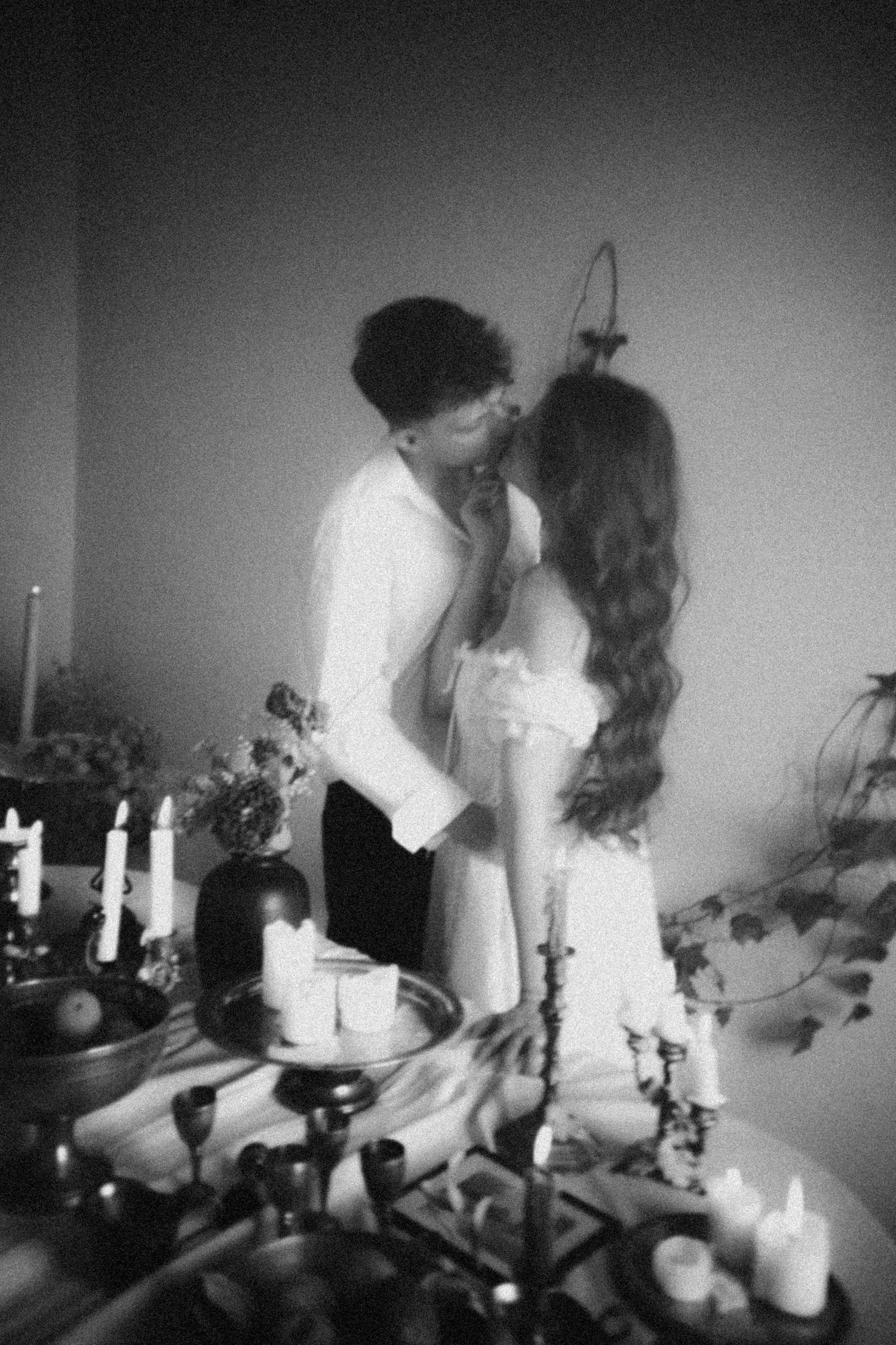 Intimate black and white photography sequence captures couples sharing tender moments by candlelight.
