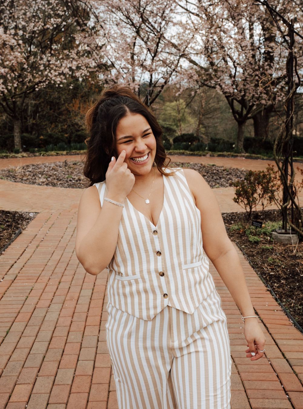 A happy high school senior smiling candidly for senior photoshoot at Hershey Gardens.