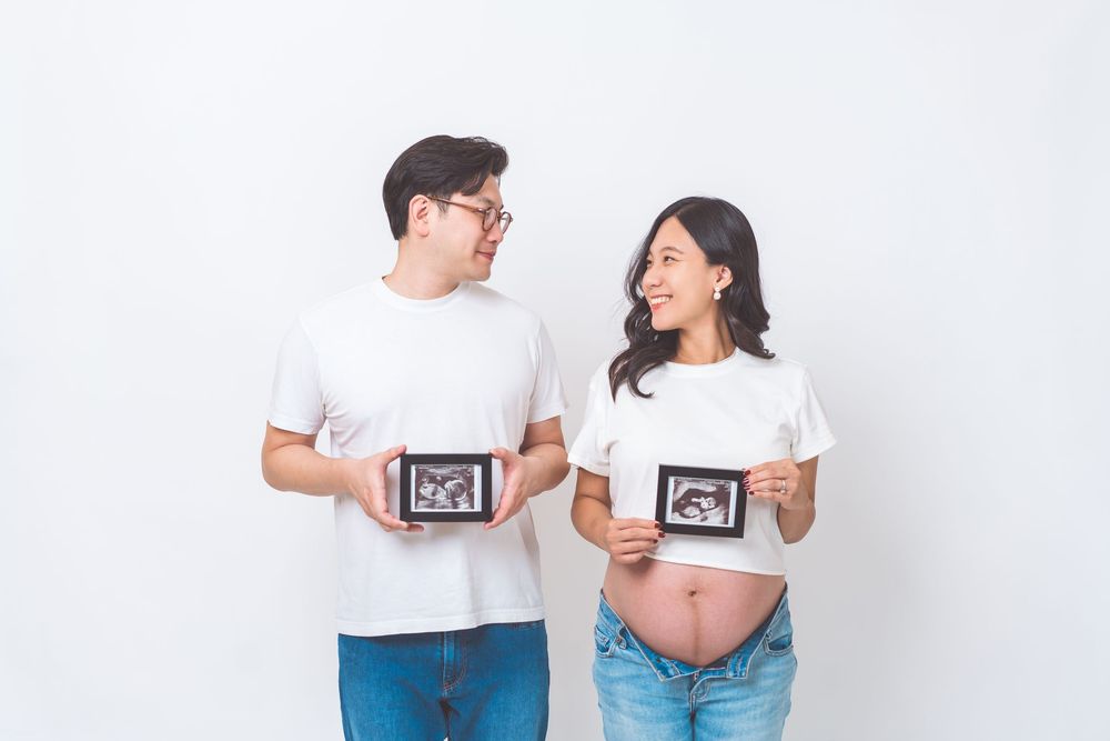 A couple in matching white t-shirts laughing and interacting in a series of candid poses against a white background.