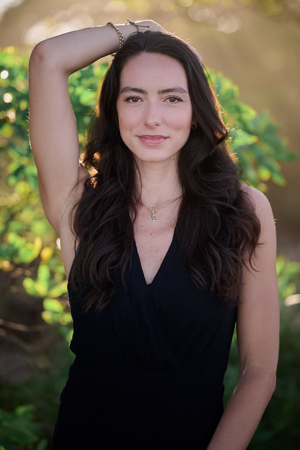 A series of outdoor portrait shots showing dark-haired woman in black top against natural bokeh background.