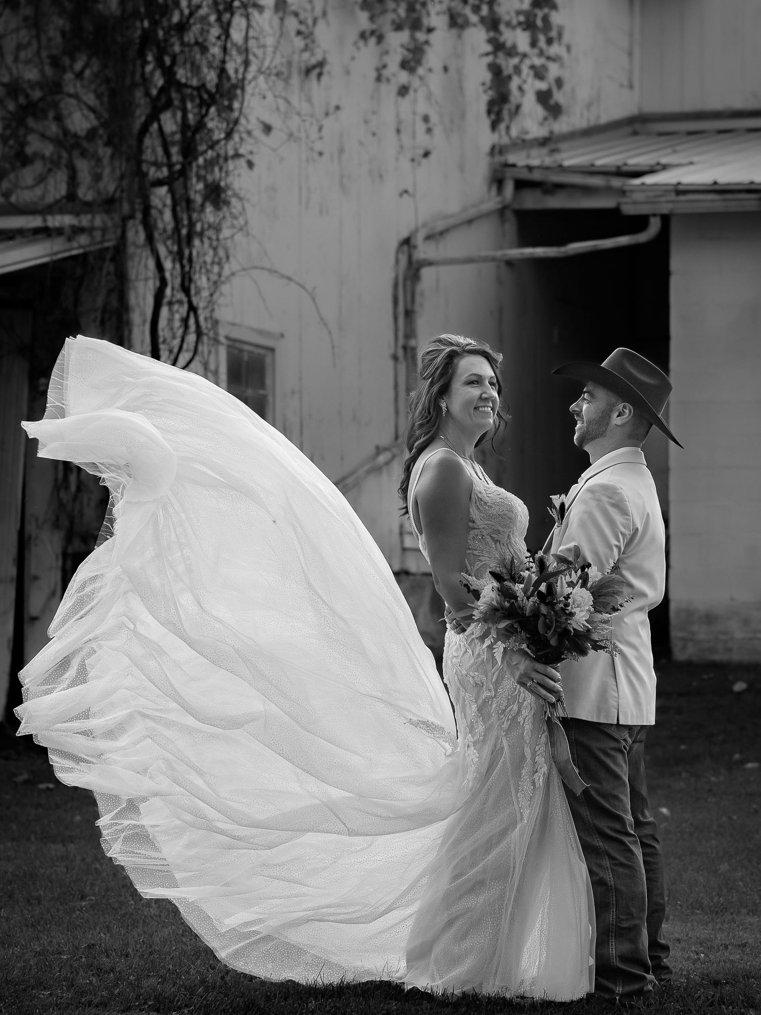 A dramatic black and white photo of a flowing white dress in motion.