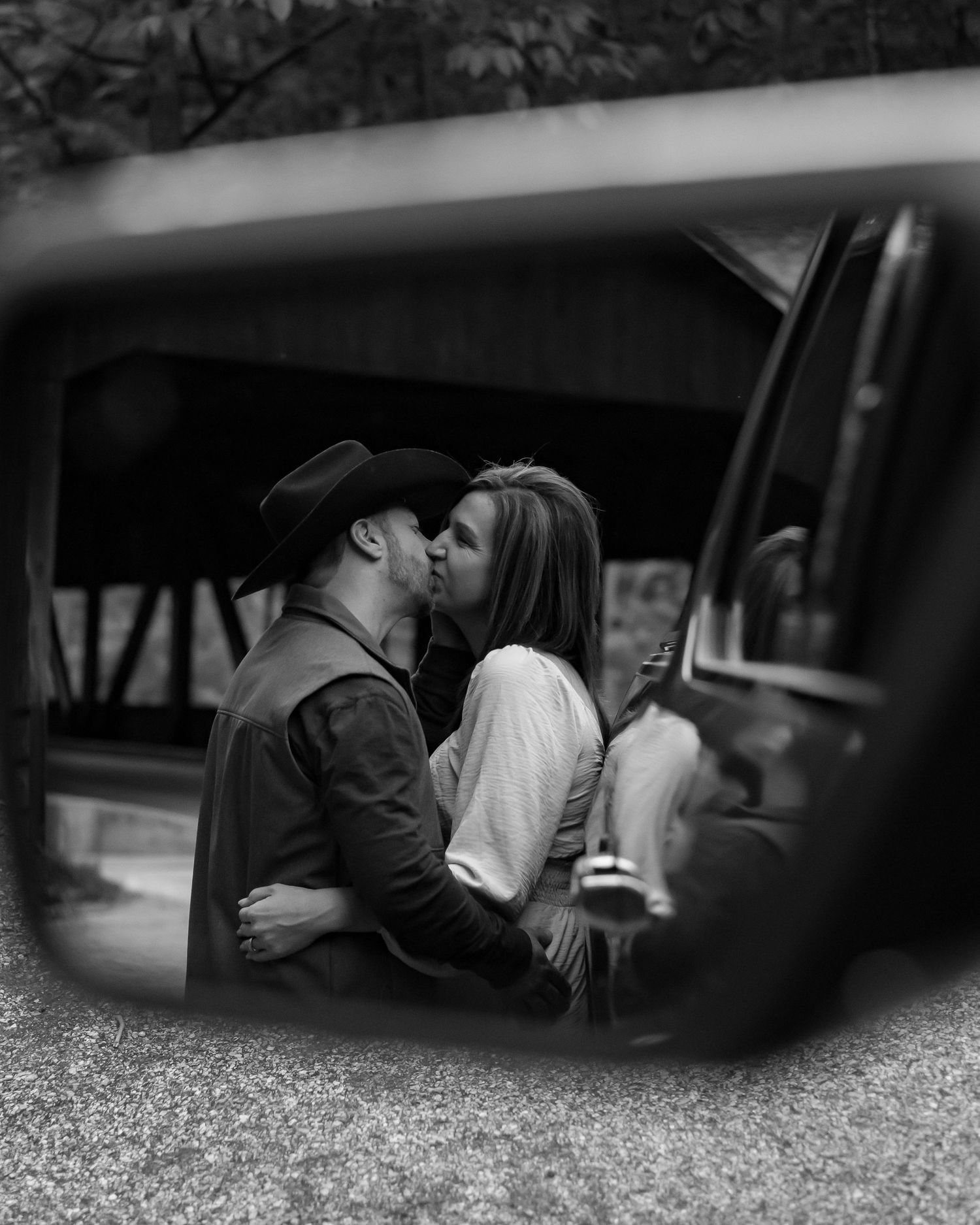 Black and white images captured through a car window showing intimate moments.