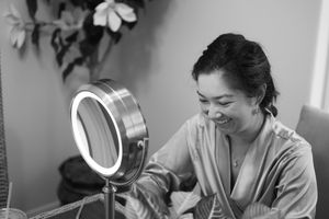 Black and white getting ready scene with makeup preparations.