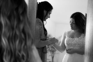 Black and white portrait shots showing wedding preparations in intimate moments of getting ready.