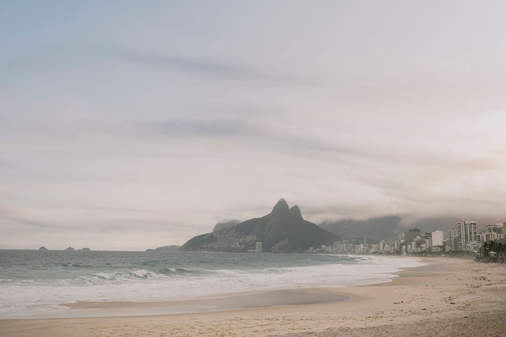 Scenic view of Ipanema beach with Two Brothers mountain shrouded in clouds, Rio de Janeiro.