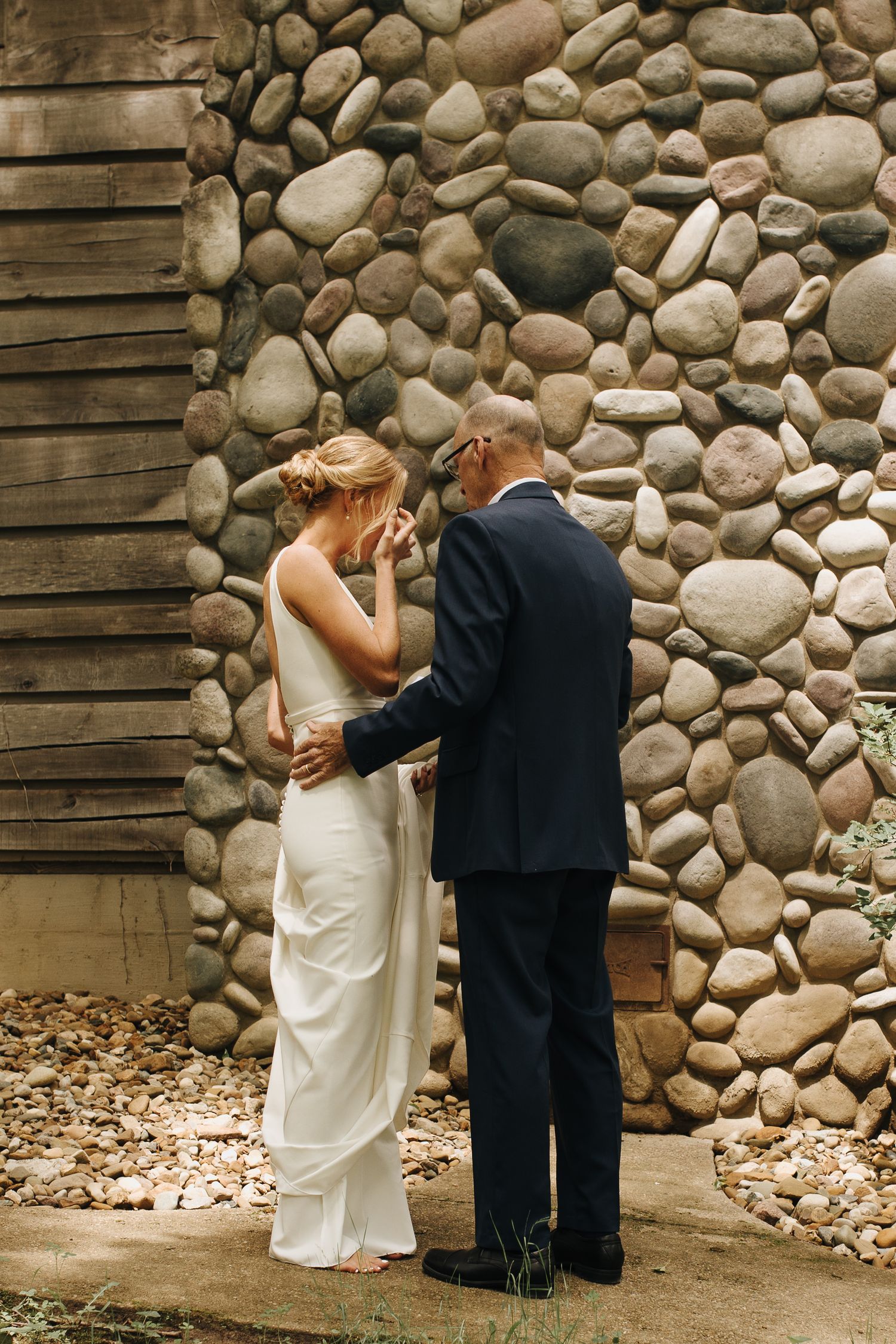 Father of the bride seeing his daughter in her wedding dress for the first time - emotional reaction photo.