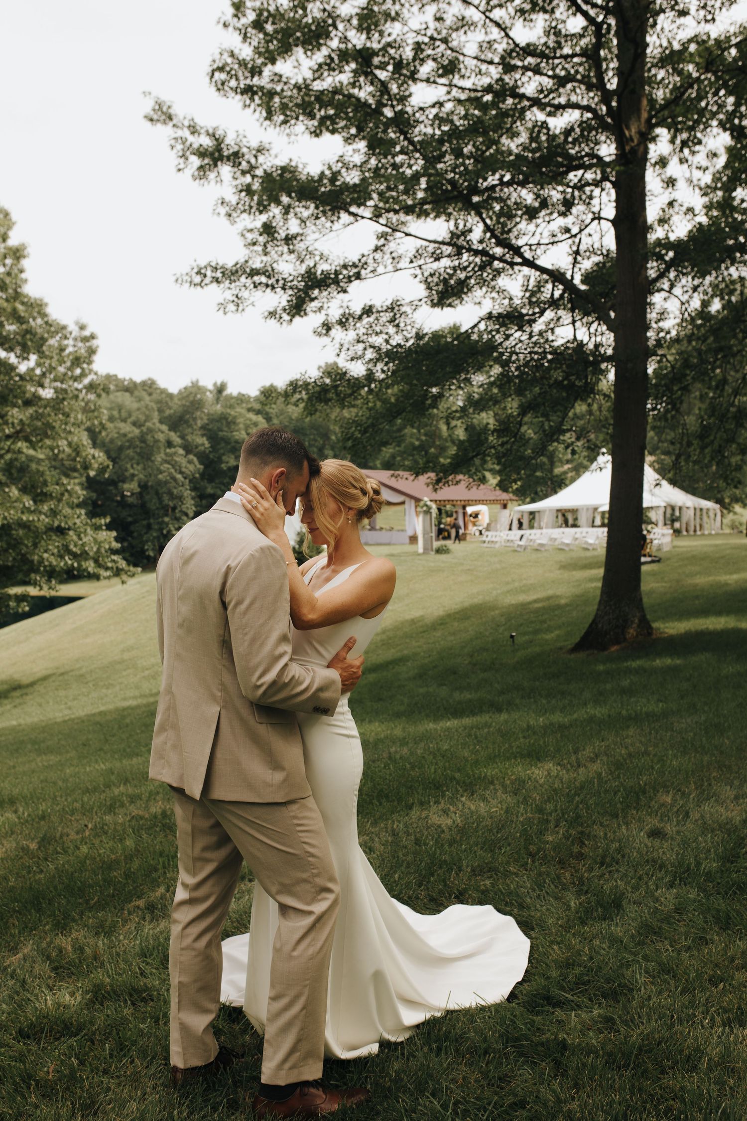 Intimate first look moment between bride and groom surrounded by trees and soft natural light - Columbus wedding photographer