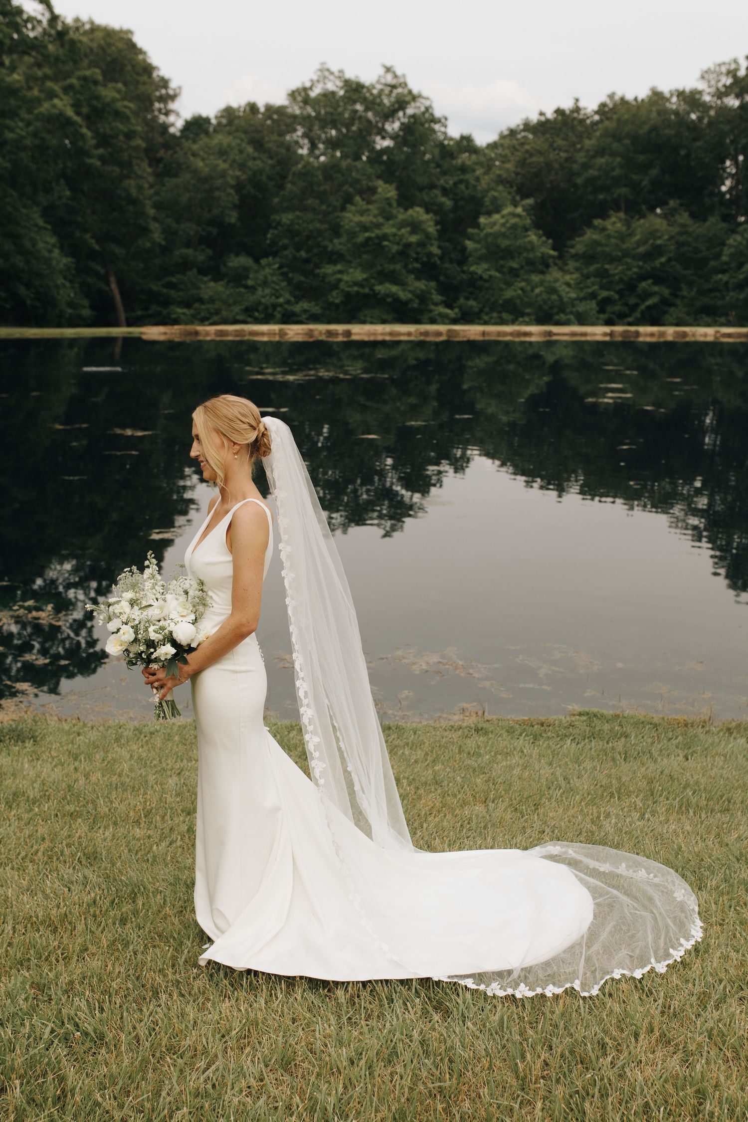 Stunning outdoor bridal portrait with natural light and neutral-toned florals on groom's family estate.