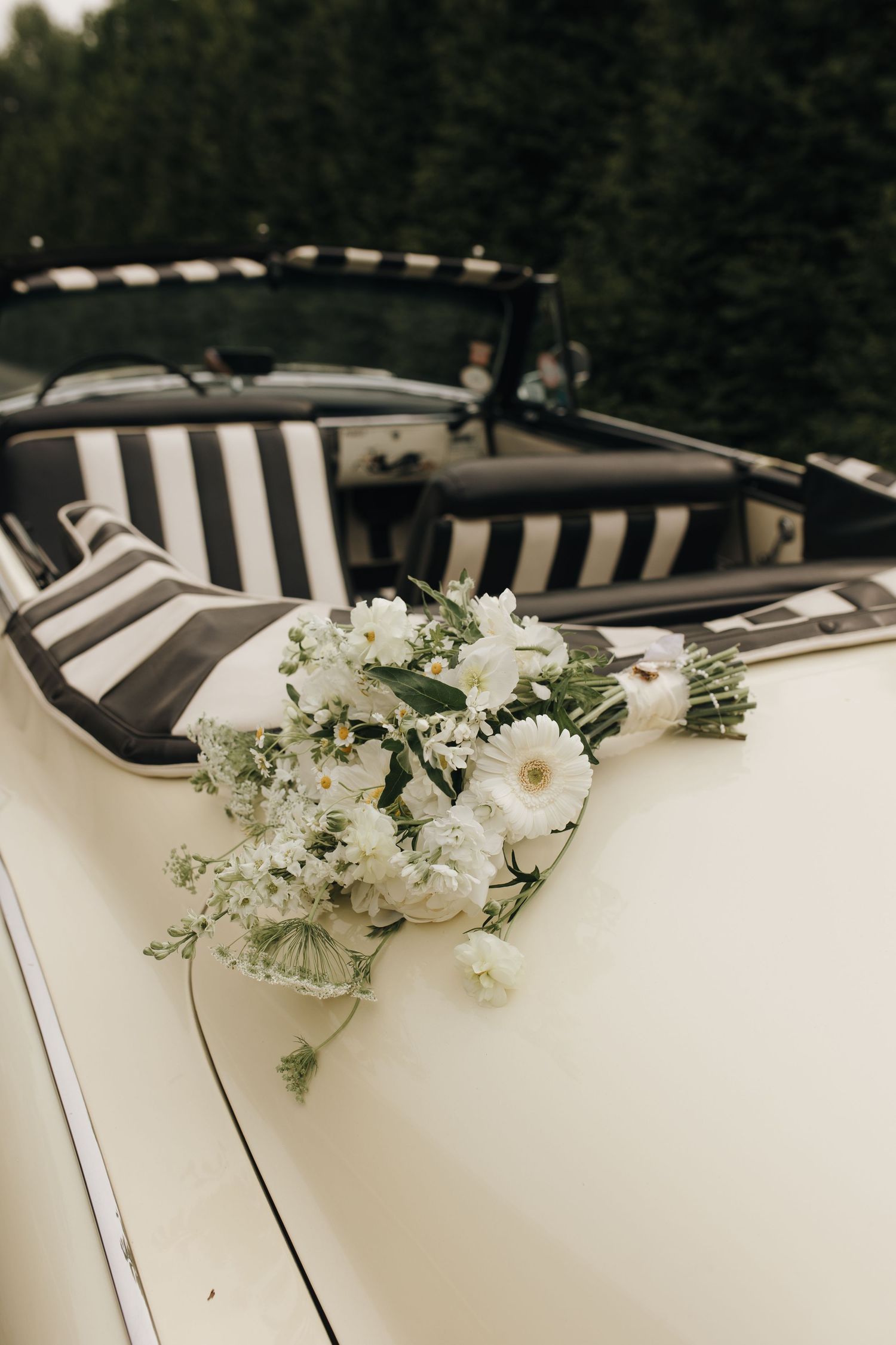 Detail shot of bride's bouquet resting on the vintage car - Columbus wedding photographer.