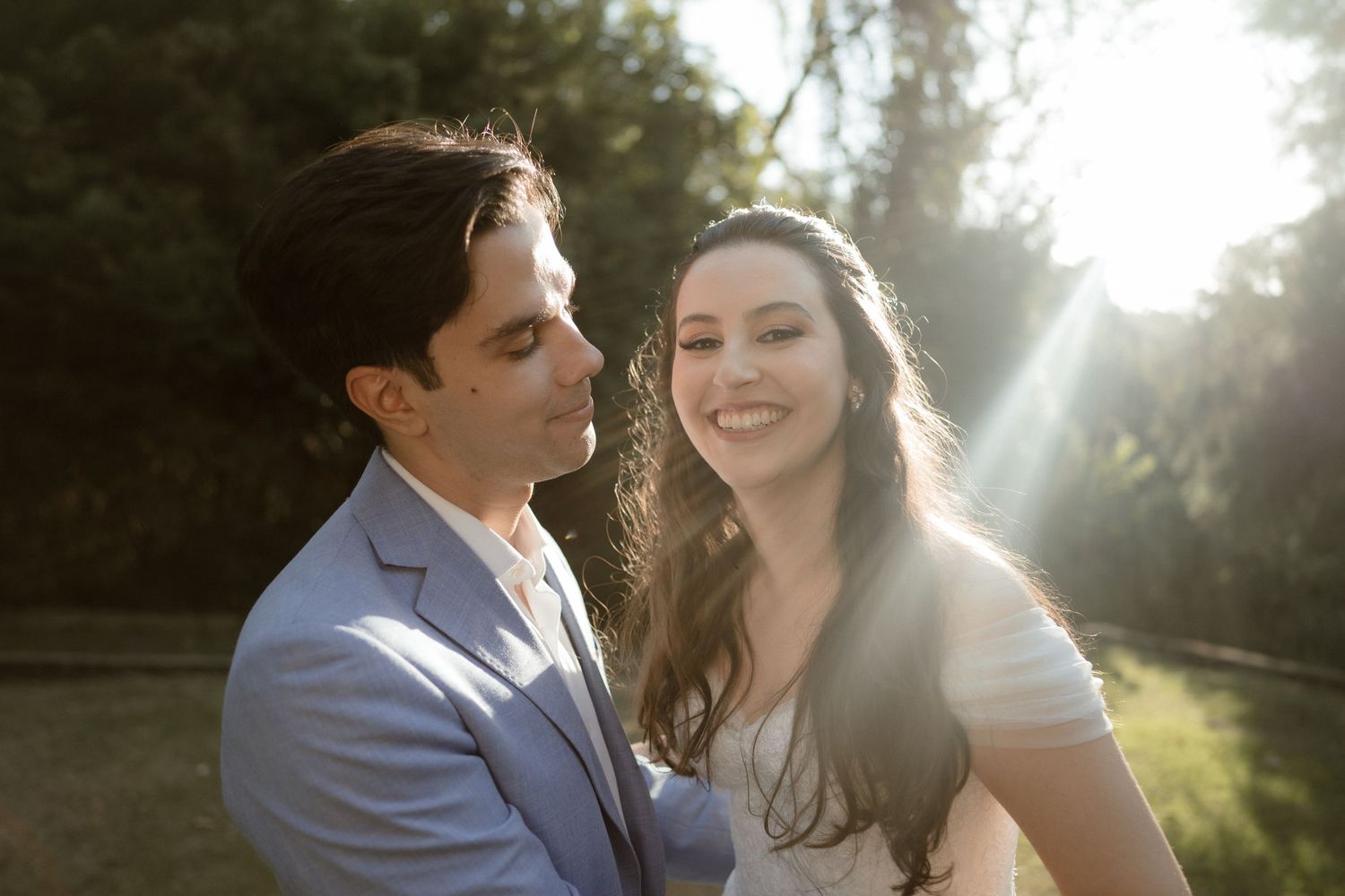 Sun-drenched wedding portraits capture romantic moments in a natural outdoor setting.