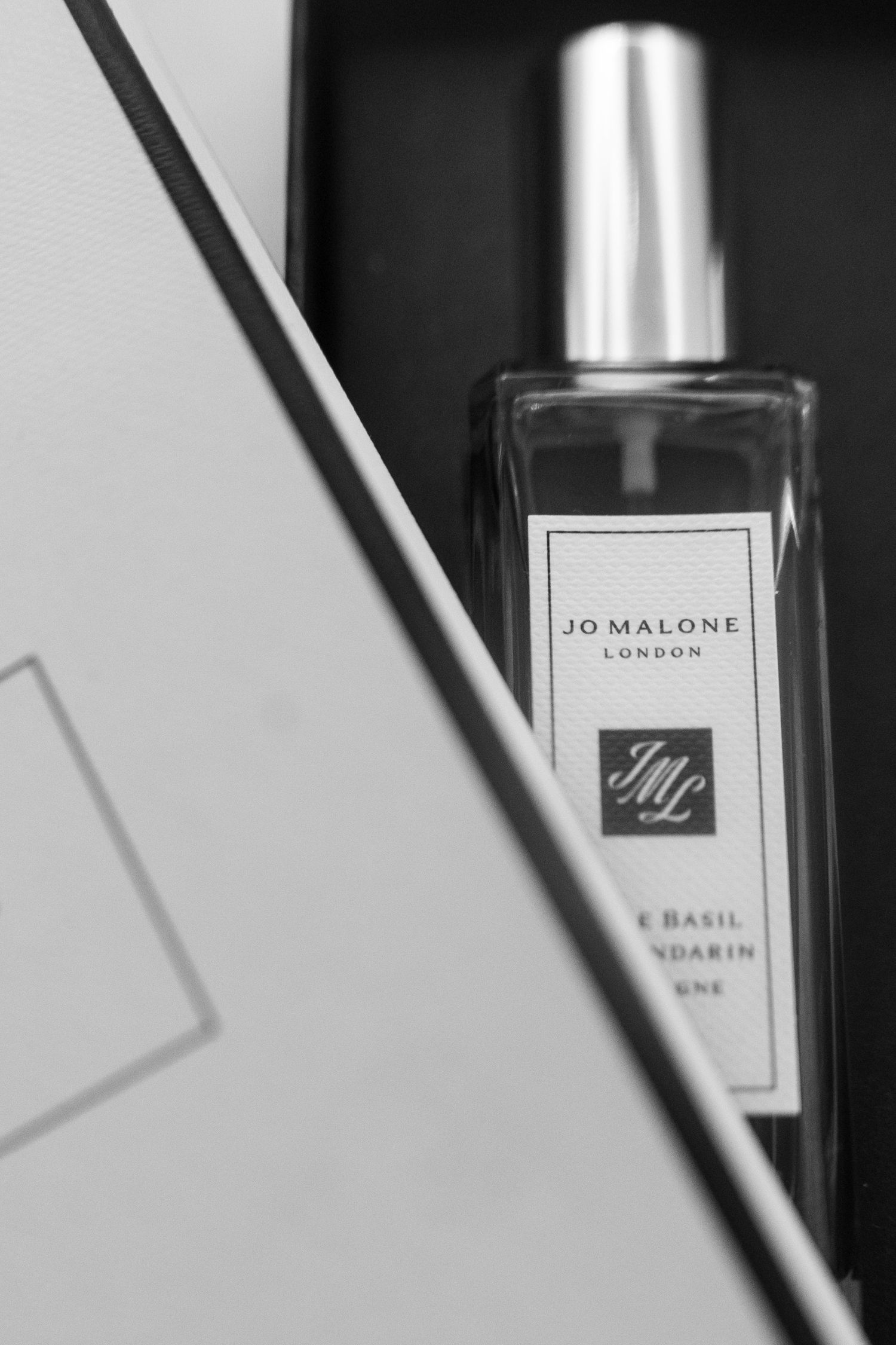 Black and white photo of Jo Malone London lime basil and mandarin cologne in an elegant gift box.