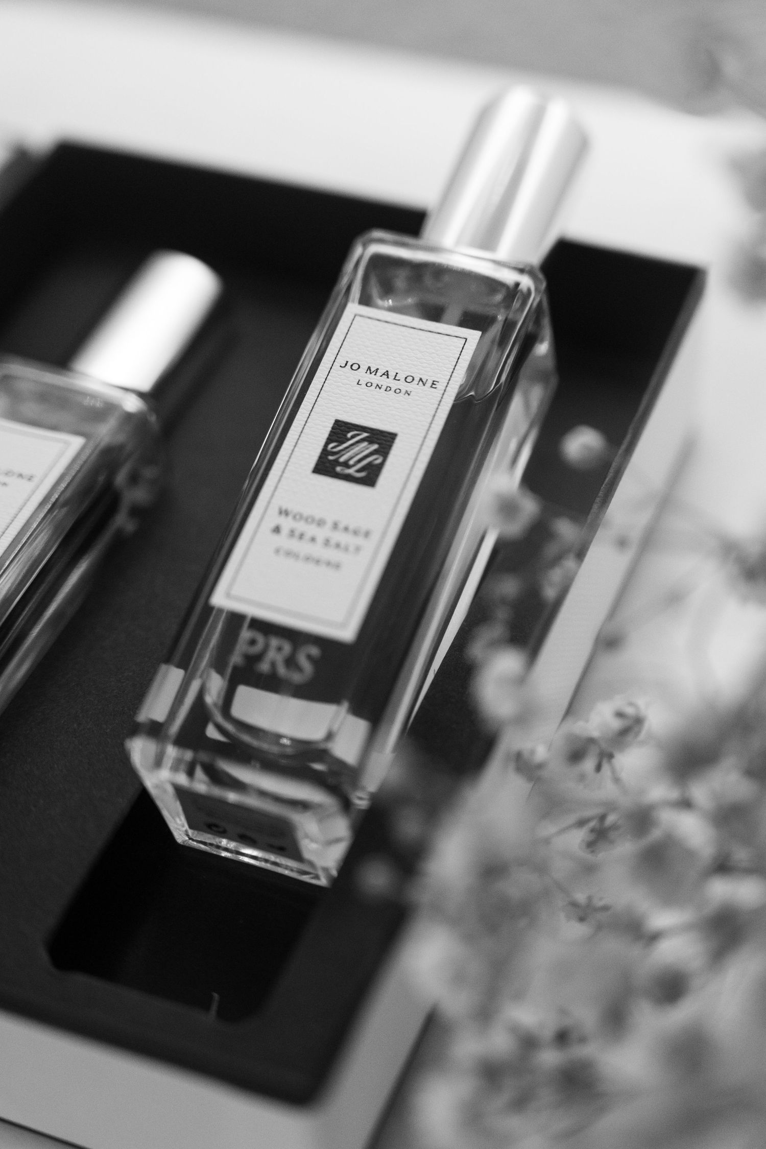 Black and white close-up of Jo Malone Wood Sage and Sea Salt cologne in gift box.