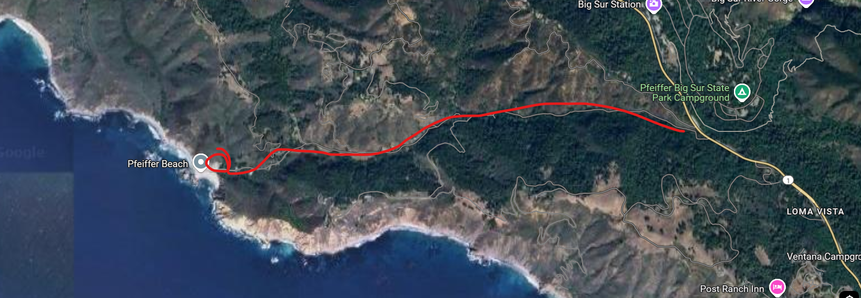 Satellite view of rugged California coastline showing winding red route along Pacific Coast Highway near Big Sur.