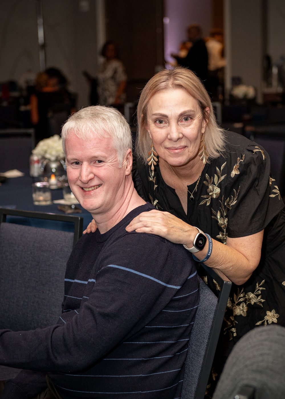 Guests enjoying a social gathering around gaming tables at an evening event.