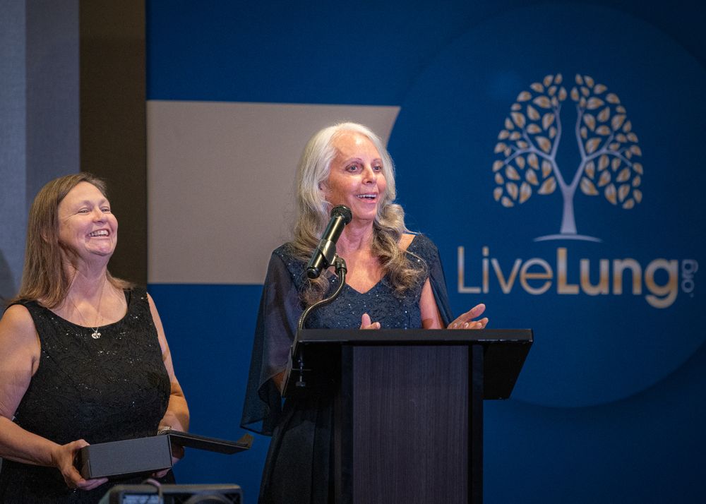 People engaging in conversation at a LiveLung branded corporate event.