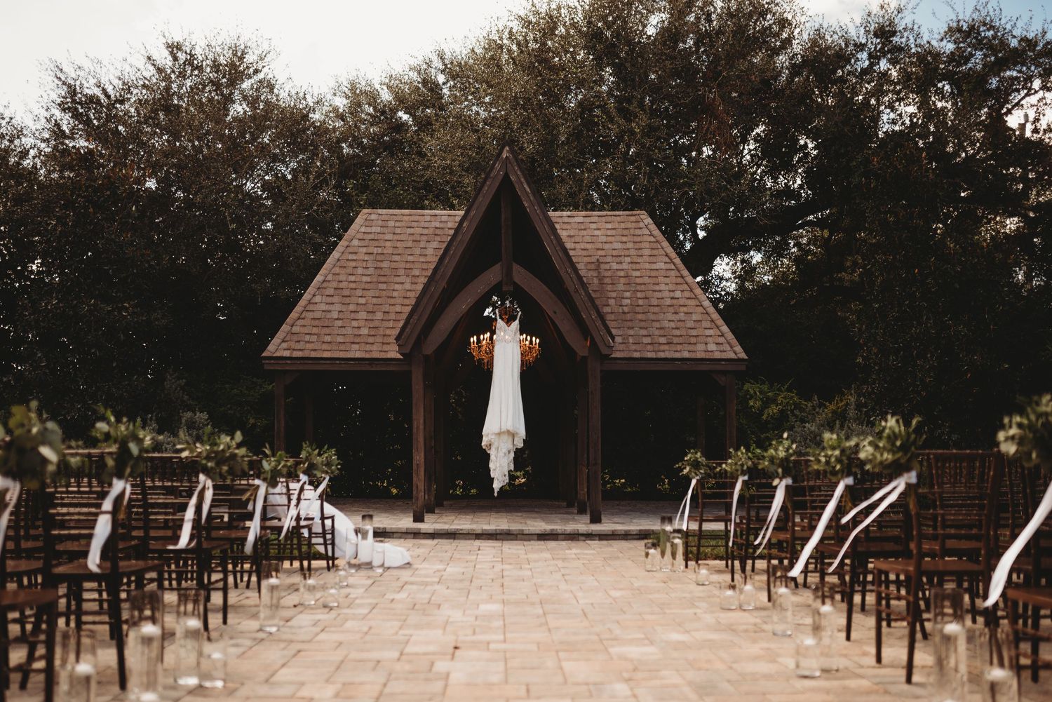 A wedding chapel with wooden architecture and chairs set up for an outdoor ceremony.