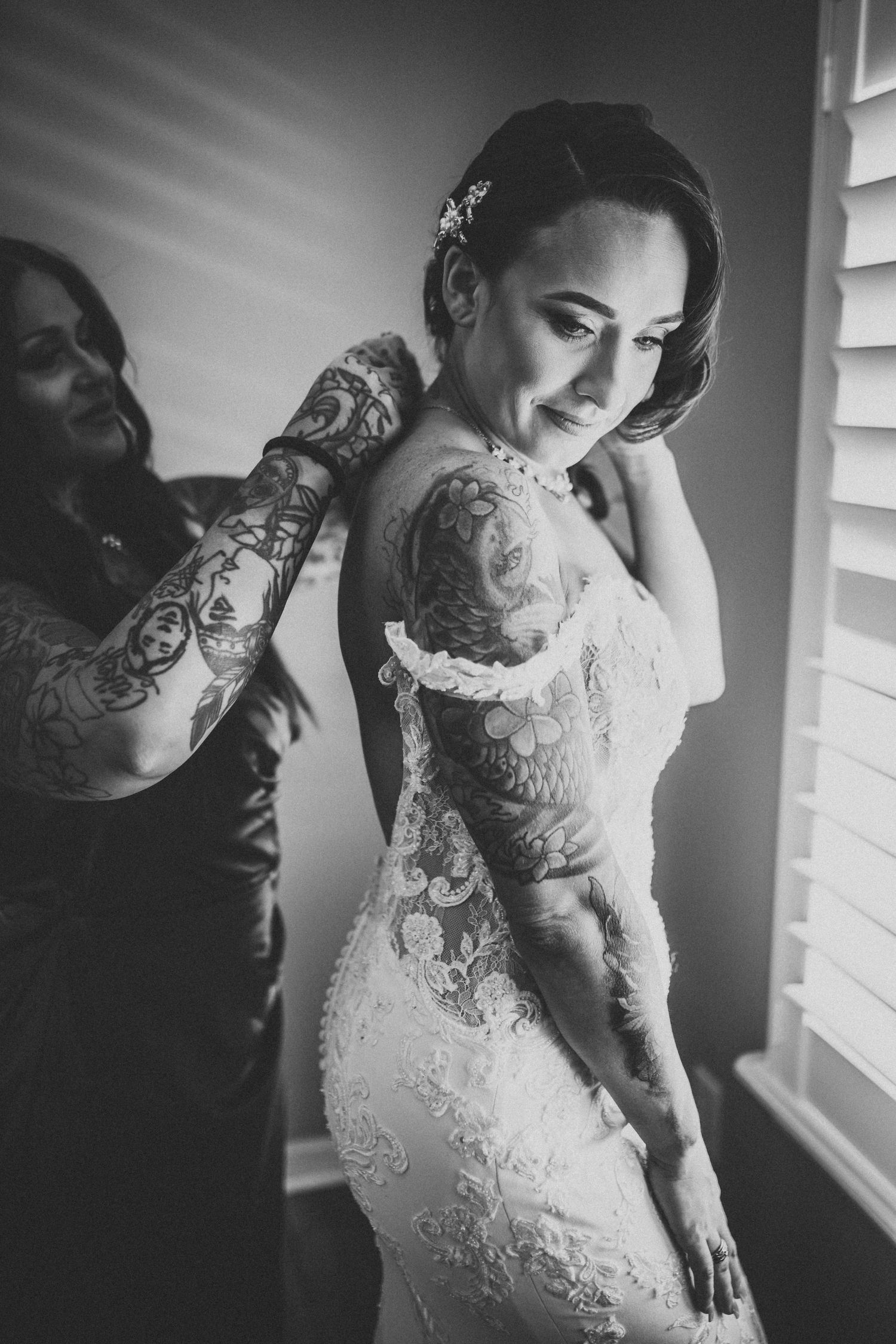 Black and white portrait showing intricate lace details of a wedding dress.