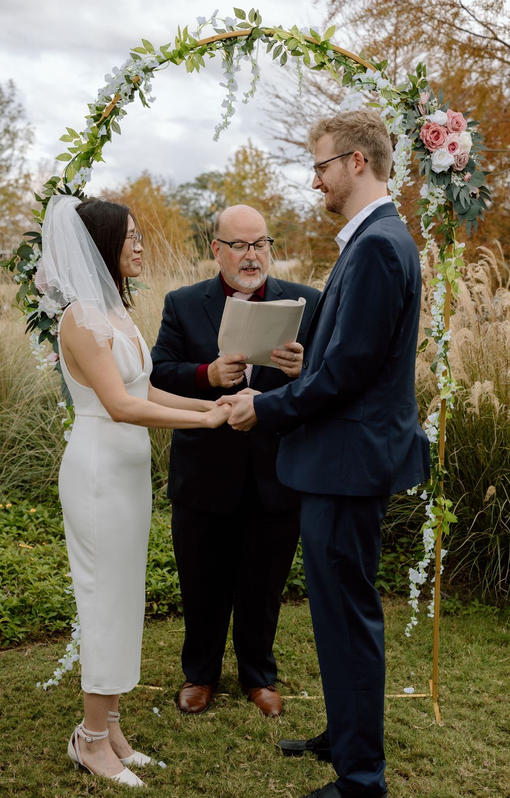 bride and groom during ceremony holding hands and facing each other