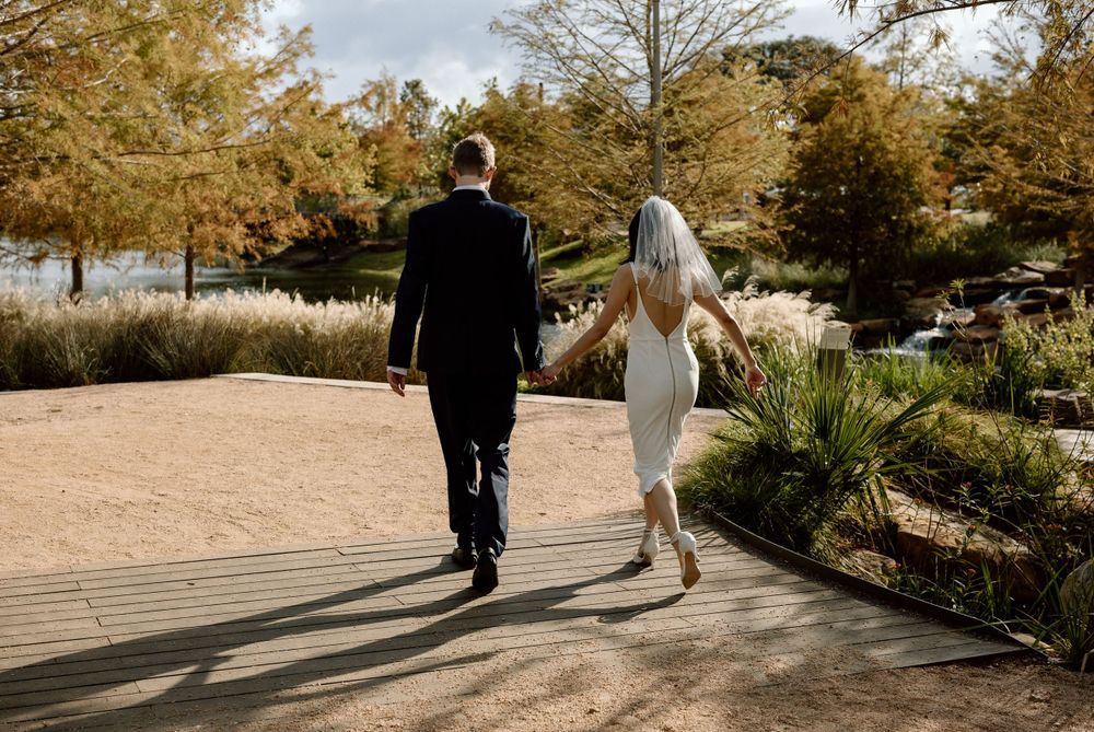 bride and groom walking away on Texas A&M campus