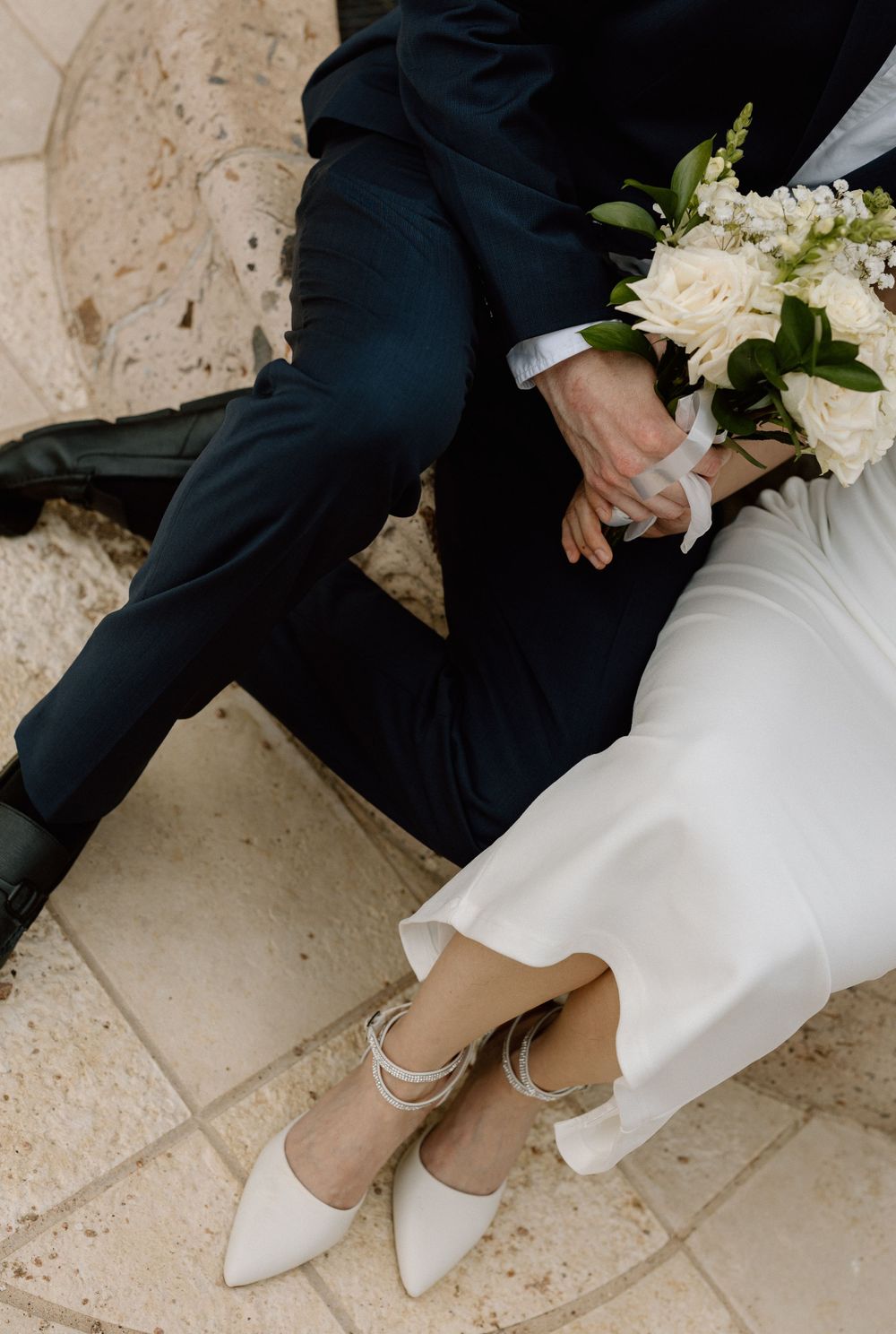 bride and groom legs and bouquet
