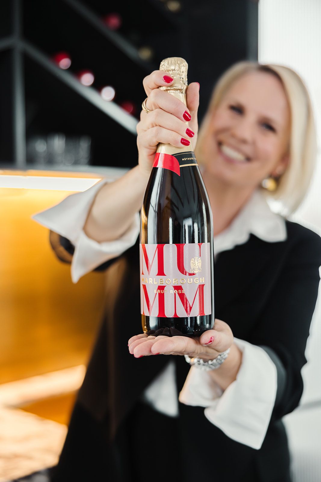 Anne Zwahlen holding a wine on her brand day celebration
